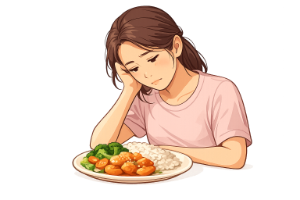 A women hunched over a plate of food, unable to eat due to loss of appetite.